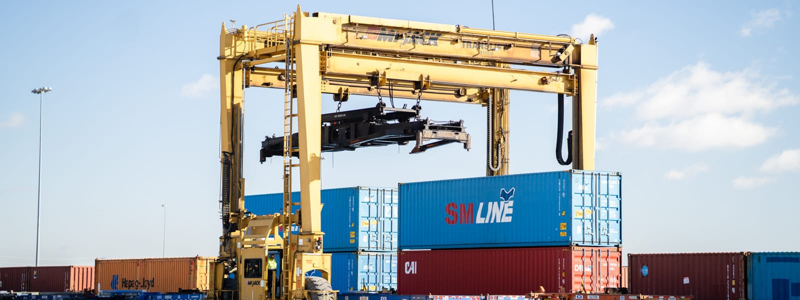 Rubber tired gantry cranes working over stacked containers at a railyard
