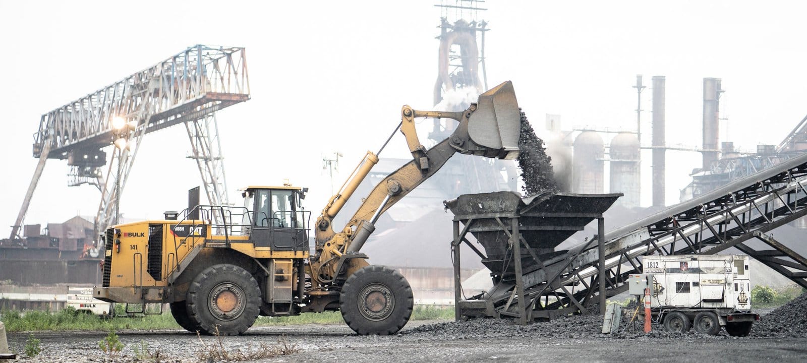 Front-end loader dumping material at an earth moving site
