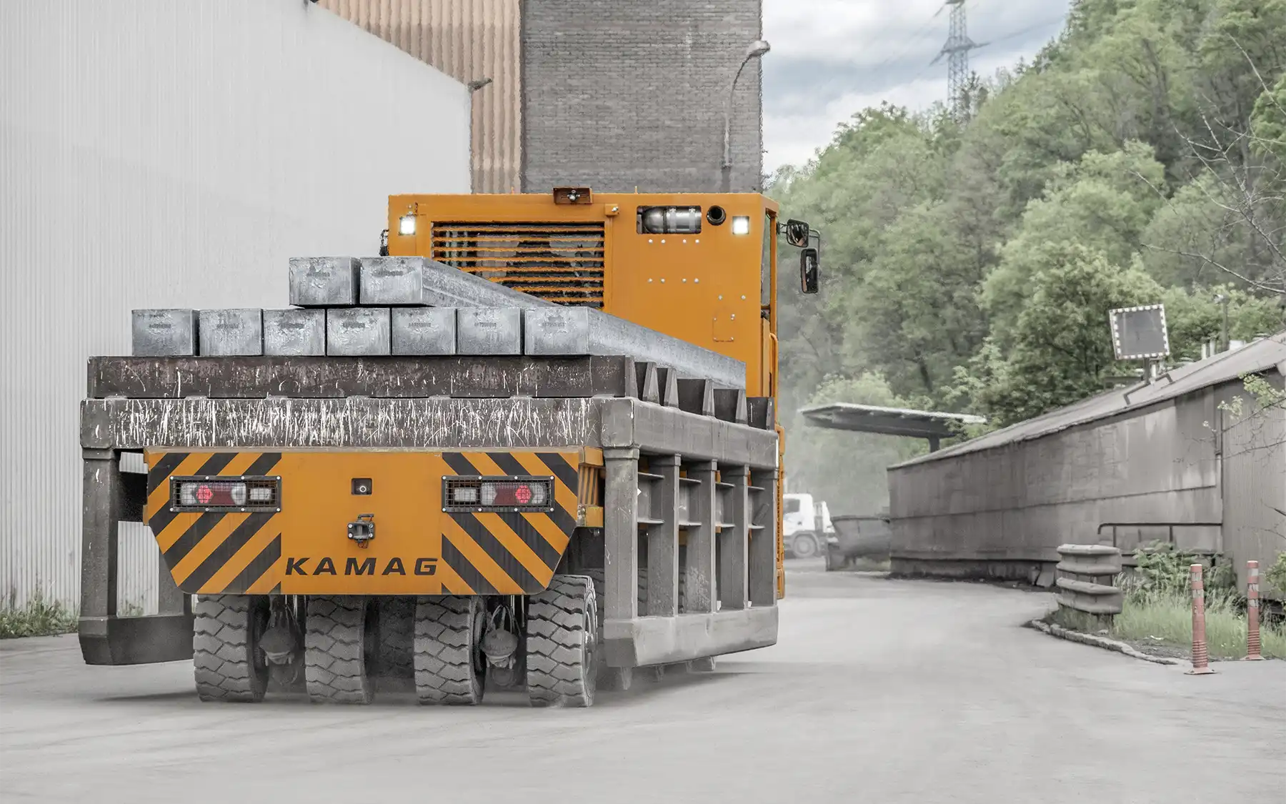 KAMAG industrial transporter carrying steel blooms at a mill