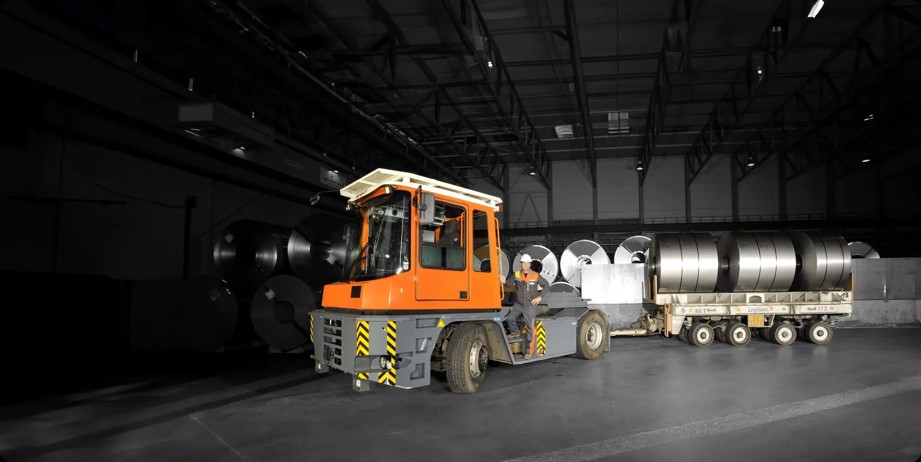 MAFI heavy tractor coupled to a multi-axle trailer loaded with steel coils inside a steel mill